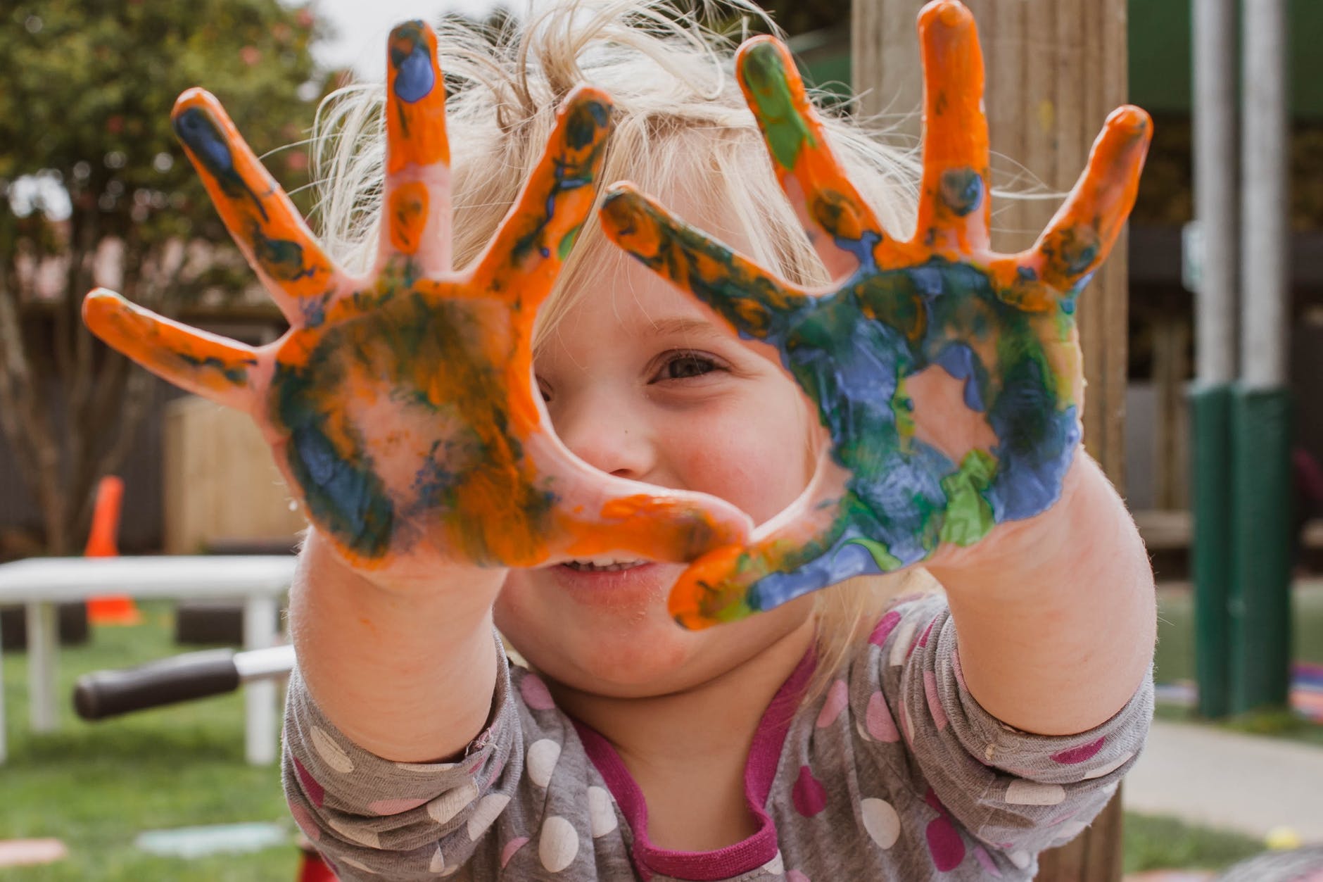 photo of little girl s hands covered with paint